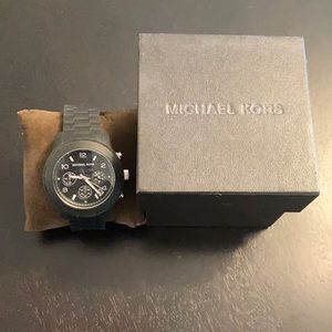 Women’s black with silver buckle watch.